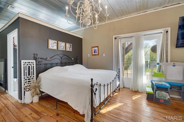 305 N Main St, Saint Genevieve, MO 63670 - bedroom with a chandelier, hardwood / wood-style flooring, and access to exterior