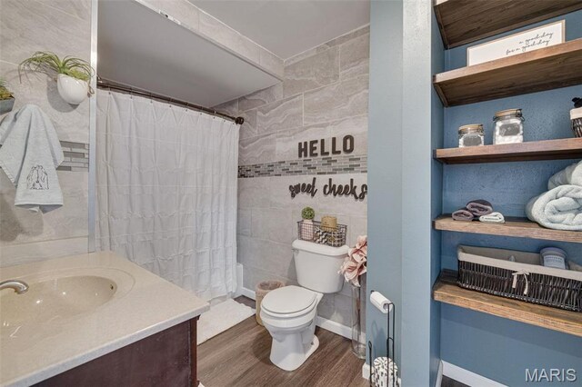 305 N Main St, Saint Genevieve, MO 63670 - bathroom with tile walls, wood finished floors, toilet, a shower with curtain, and vanity