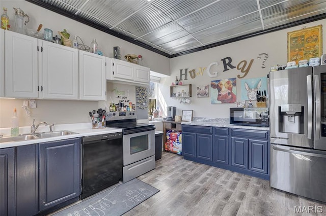 305 N Main St, Saint Genevieve, MO 63670 - kitchen featuring black appliances, a sink, blue cabinetry, light countertops, and white cabinetry