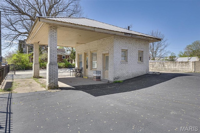 305 N Main St, Saint Genevieve, MO 63670 - view of front of house with brick siding, fence, and metal roof
