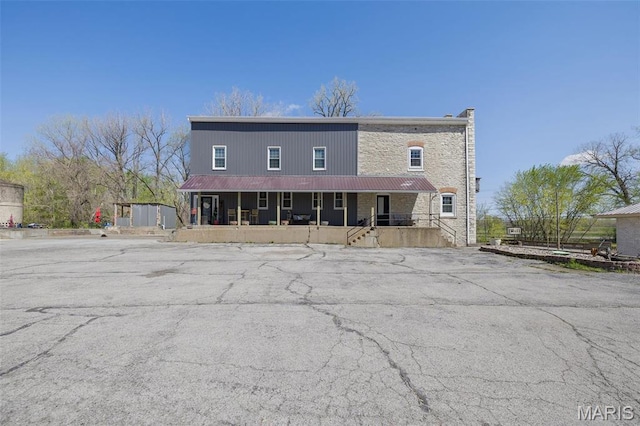 305 N Main St, Saint Genevieve, MO 63670 - view of front of property featuring covered porch, metal roof, and stone siding