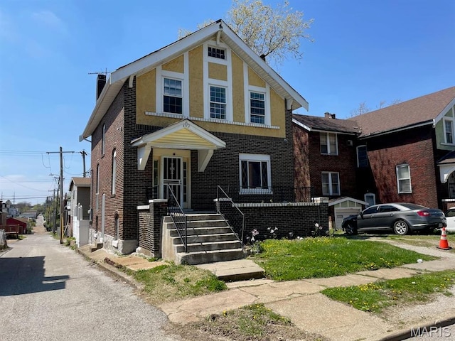 4972 Thekla Ave, Saint Louis, MO 63115 - view of front facade featuring a chimney and brick siding