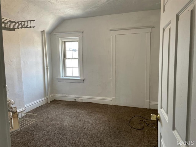 4972 Thekla Ave, Saint Louis, MO 63115 - additional living space featuring carpet floors, vaulted ceiling, a textured ceiling, and baseboards