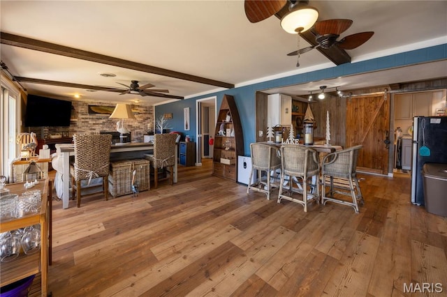 1757 Rue Marseilles, Bonne Terre, MO 63628 - dining room with ceiling fan, a barn door, wood-type flooring, and beam ceiling