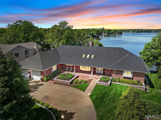 27 Lake Forest Cir, Lake St Louis, MO 63367 - view of front of house featuring brick siding, roof with shingles, an attached garage, a water view, and a chimney