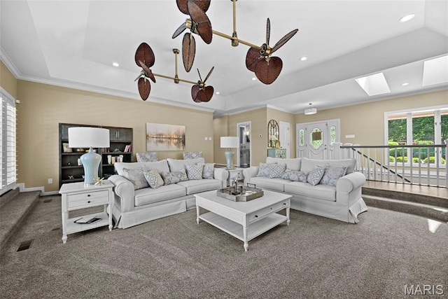 27 Lake Forest Cir, Lake St Louis, MO 63367 - carpeted living room with a tray ceiling, recessed lighting, a skylight, ornamental molding, and baseboards