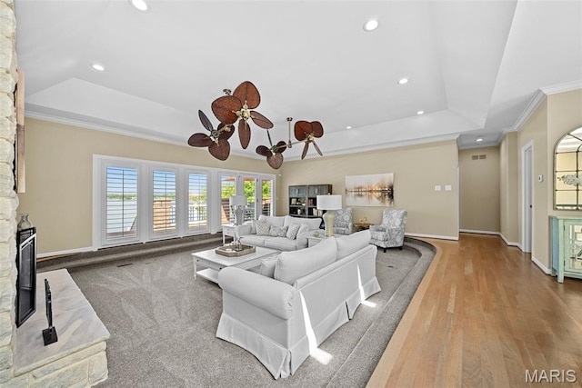 27 Lake Forest Cir, Lake St Louis, MO 63367 - living room with a tray ceiling, recessed lighting, baseboards, crown molding, and wood finished floors