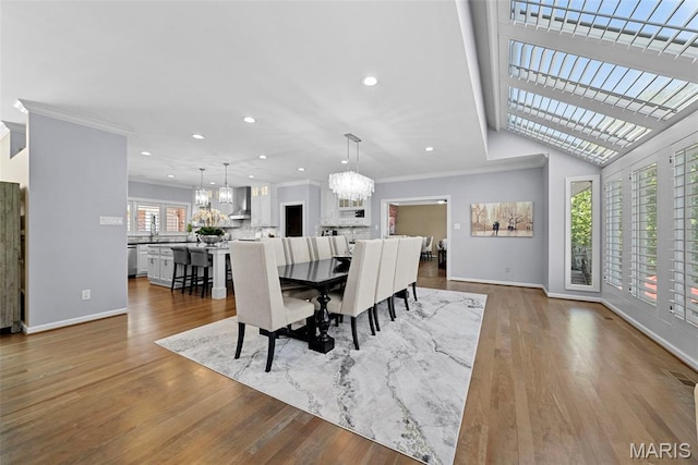27 Lake Forest Cir, Lake St Louis, MO 63367 - dining space featuring a chandelier, ornamental molding, baseboards, recessed lighting, and wood finished floors