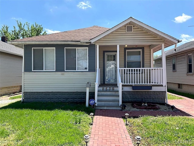 2538 Jerden Ave, Granite City, IL 62040 - view of front of home with covered porch, a front yard, and roof with shingles