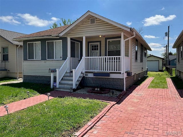 2538 Jerden Ave, Granite City, IL 62040 - view of front of property with a porch, a garage, a front lawn, decorative driveway, and an outdoor structure