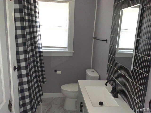 2538 Jerden Ave, Granite City, IL 62040 - bathroom featuring marble look tiles, toilet, a shower with curtain, vanity, and baseboards