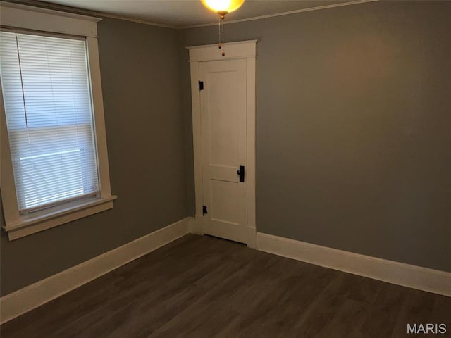 2538 Jerden Ave, Granite City, IL 62040 - spare room featuring baseboards, dark wood-type flooring, and crown molding
