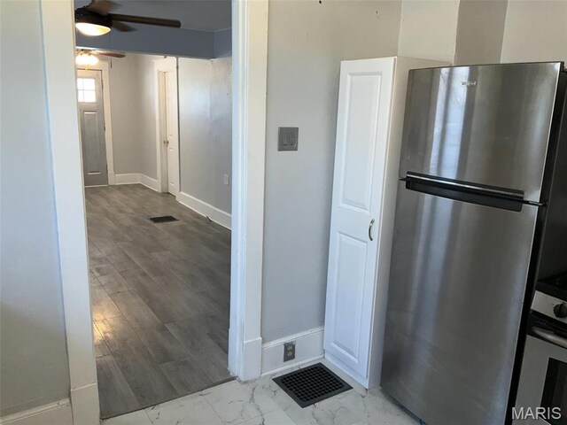 2538 Jerden Ave, Granite City, IL 62040 - kitchen with freestanding refrigerator, a ceiling fan, baseboards, and marble finish floors