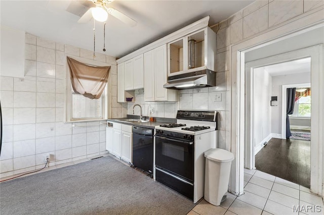 3125 Miami St, Saint Louis, MO 63118 - kitchen featuring white range with gas stovetop, dishwasher, tile walls, light tile patterned floors, and under cabinet range hood