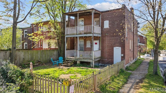 3125 Miami St, Saint Louis, MO 63118 - multi unit property with a balcony, brick siding, and a fenced backyard