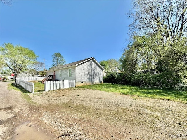 113 N Long St, Bonne Terre, MO 63628 - view of side of property with a fenced front yard, dirt driveway, and crawl space