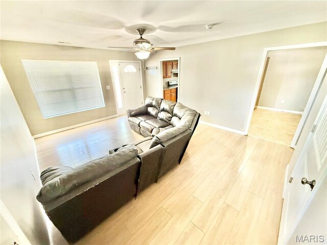 113 N Long St, Bonne Terre, MO 63628 - living room with light wood-style floors, a ceiling fan, and baseboards