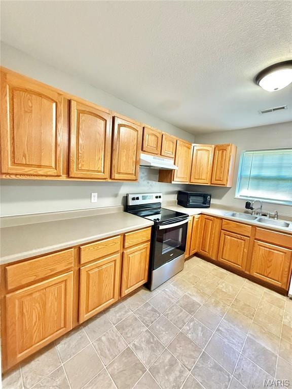 113 N Long St, Bonne Terre, MO 63628 - kitchen with electric stove, a sink, under cabinet range hood, light countertops, and a textured ceiling