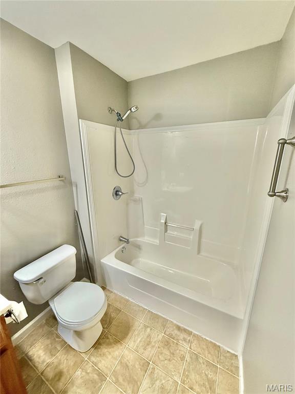 113 N Long St, Bonne Terre, MO 63628 - bathroom with toilet,  shower combination, and tile patterned flooring
