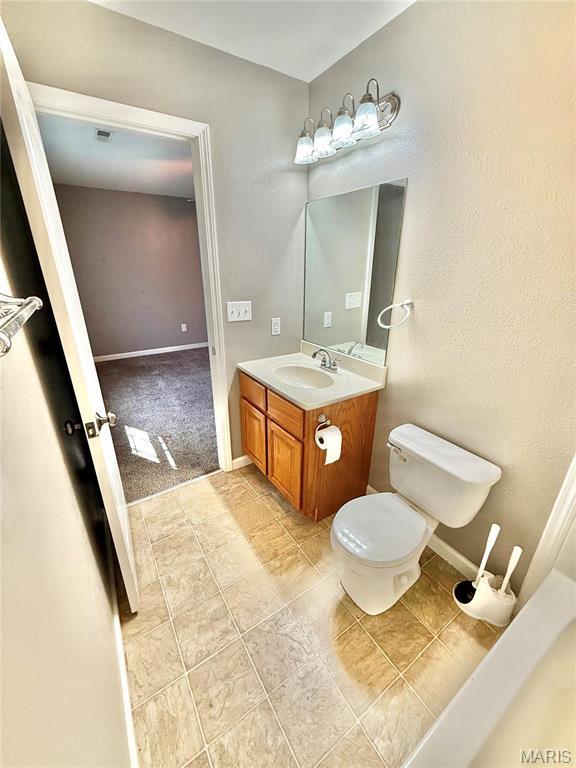 113 N Long St, Bonne Terre, MO 63628 - bathroom with vanity, toilet, baseboards, and tile patterned floors