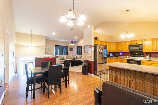 16910 Lawrence Dr, Saint Robert, MO 65584 - dining room with a chandelier, light wood-style flooring, arched walkways, and high vaulted ceiling