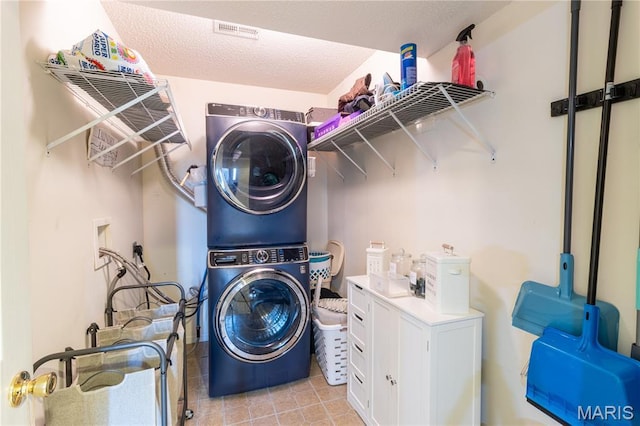 16910 Lawrence Dr, Saint Robert, MO 65584 - washroom with stacked washer and clothes dryer and light tile patterned floors