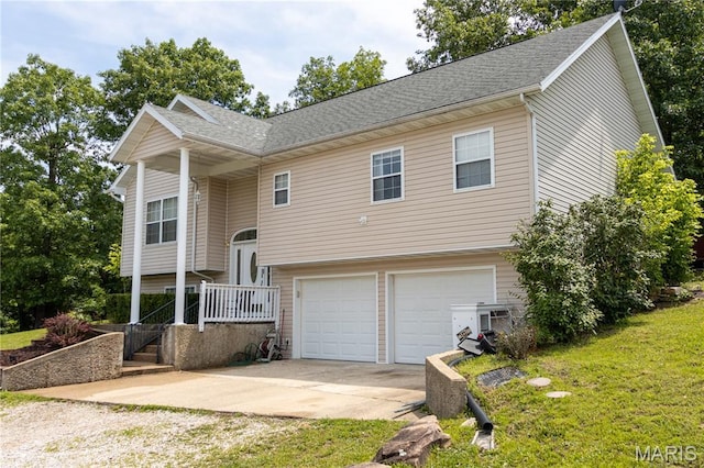 16910 Lawrence Dr, Saint Robert, MO 65584 - bi-level home featuring concrete driveway, a garage, and a front lawn