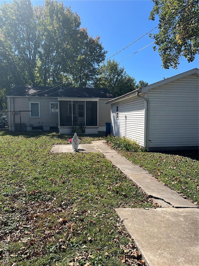 1717 Spring Ave, Granite City, IL 62040 - rear view of house featuring a lawn and a sunroom
