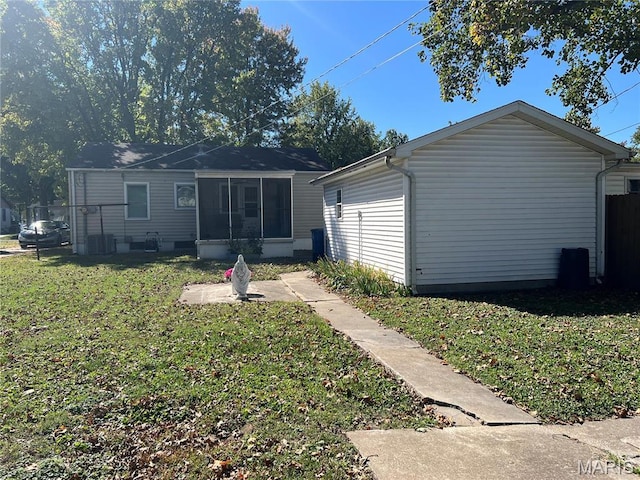 1717 Spring Ave, Granite City, IL 62040 - back of property featuring a lawn and a sunroom