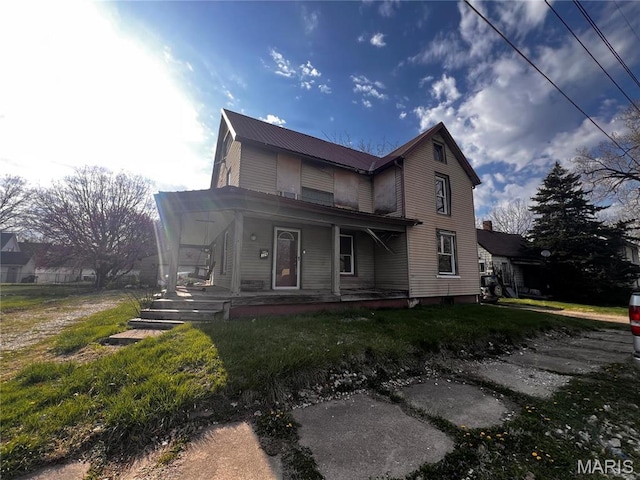 view of front facade featuring covered porch and metal roof