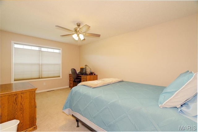bedroom featuring light colored carpet, baseboards, and ceiling fan