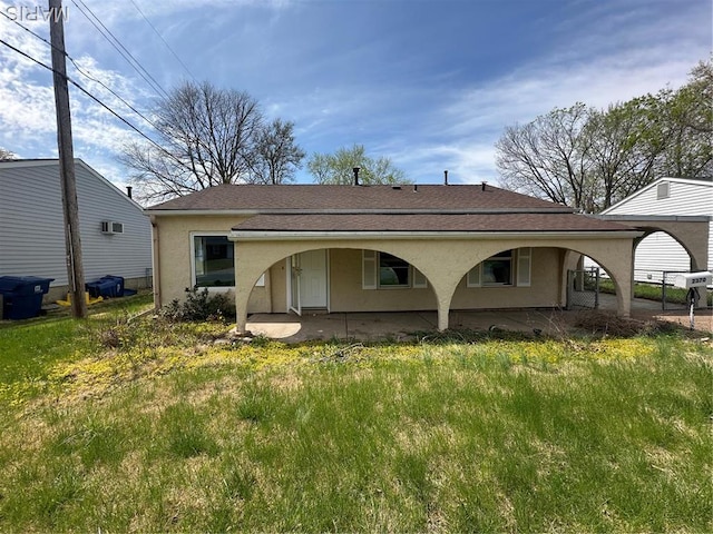 2370 Hawthorne Manor Dr, Florissant, MO 63031 - rear view of property featuring stucco siding and roof with shingles