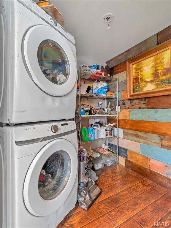 2822 State Rd W, Eureka, MO 63025 - laundry area featuring stacked washing machine and dryer and wooden walls