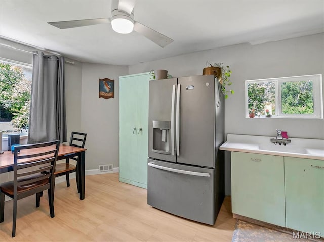 2822 State Rd W, Eureka, MO 63025 - kitchen featuring stainless steel refrigerator with ice dispenser, green cabinets, ceiling fan, light countertops, and light wood-style floors