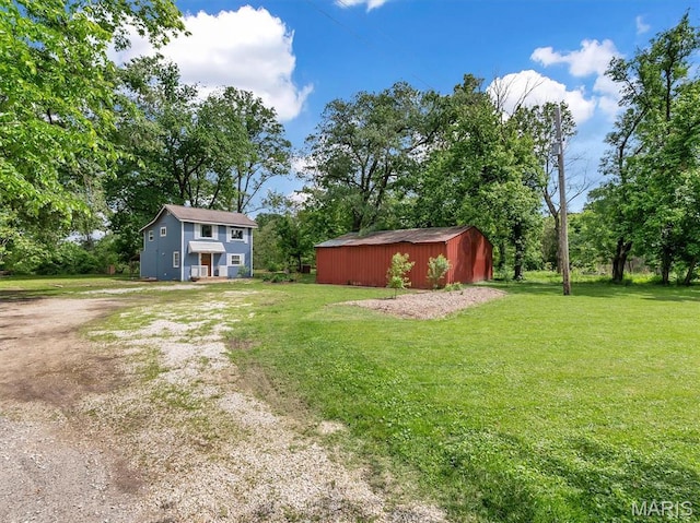 2822 State Rd W, Eureka, MO 63025 - view of grassy yard featuring an outbuilding, a shed, and driveway