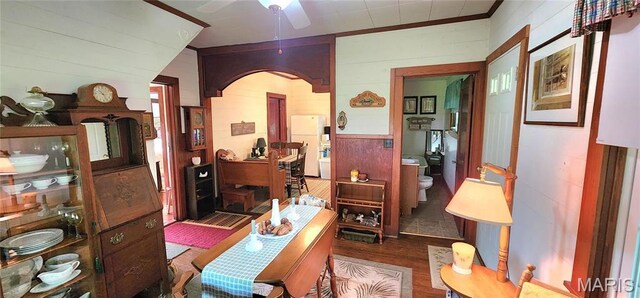 500 Church St, Chester, IL 62233 - living room with wood walls, arched walkways, wood finished floors, and a ceiling fan