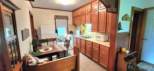 500 Church St, Chester, IL 62233 - kitchen featuring white appliances, light countertops, a sink, crown molding, and brown cabinetry