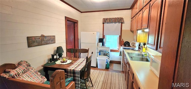 500 Church St, Chester, IL 62233 - kitchen featuring white appliances, ornamental molding, light countertops, wood finished floors, and brown cabinets