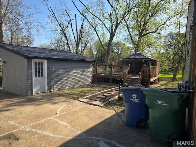 view of patio featuring a gazebo, a wooden deck, and an outdoor structure