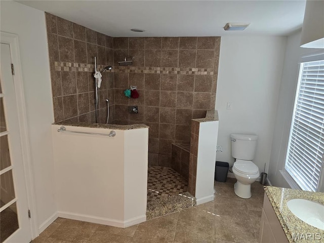 full bath with walk in shower, baseboards, toilet, vanity, and tile patterned floors