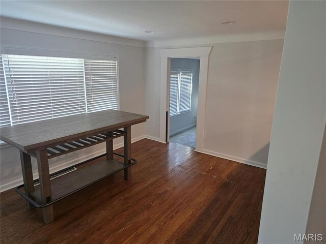 dining area with dark wood finished floors and baseboards