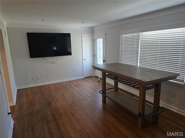 dining area featuring wood finished floors and baseboards