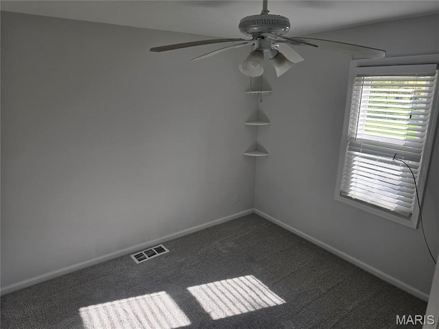 spare room featuring ceiling fan, baseboards, and dark colored carpet