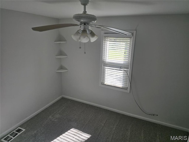 carpeted empty room featuring ceiling fan and baseboards