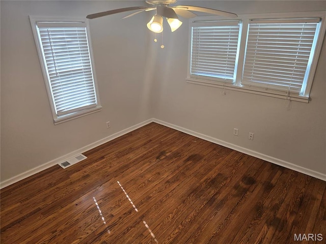 spare room with ceiling fan, baseboards, and wood finished floors