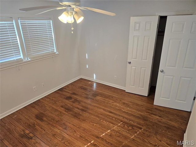 unfurnished bedroom featuring wood finished floors, baseboards, and a ceiling fan