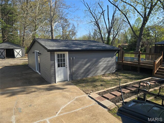 view of outbuilding featuring an outbuilding and stairway