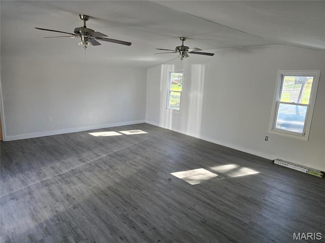 spare room featuring lofted ceiling, plenty of natural light, dark wood-style flooring, and baseboards
