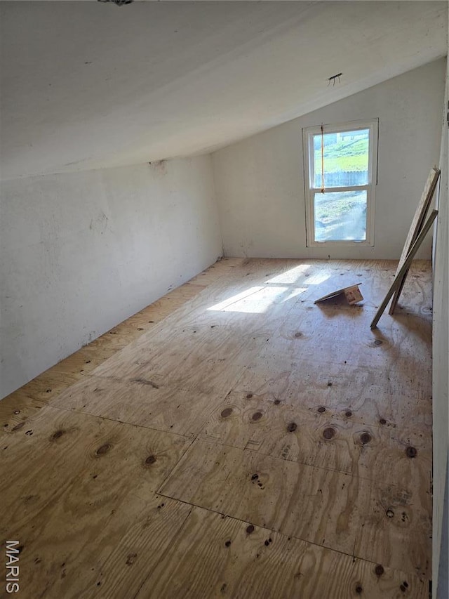 empty room with lofted ceiling