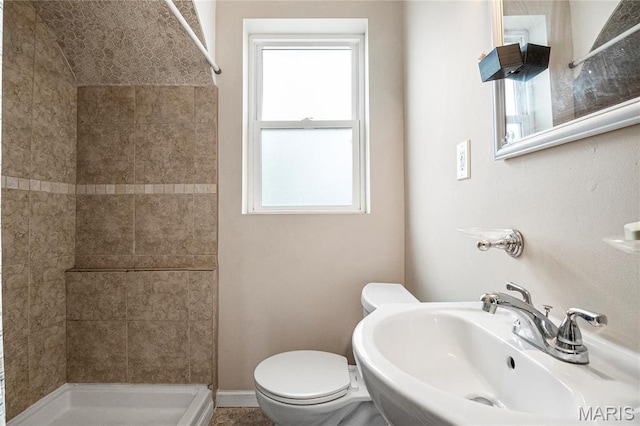 full bath featuring a sink, a shower stall, and toilet
